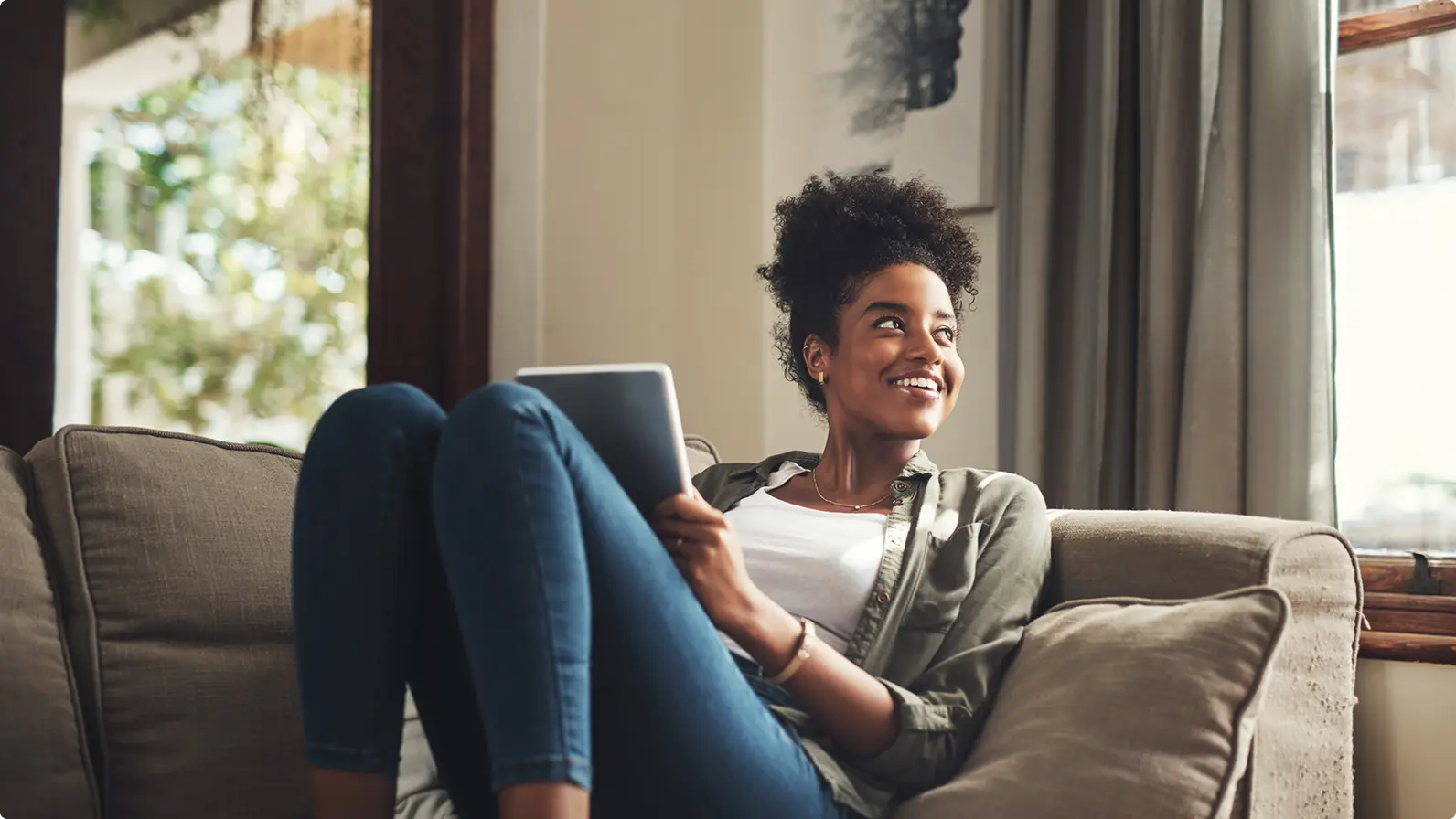 girl smiling looking up from tablet